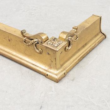 A brass fire guard, around 1900.
