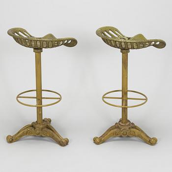 Four bar stools, painted cast iron, partly from the early 20th century.