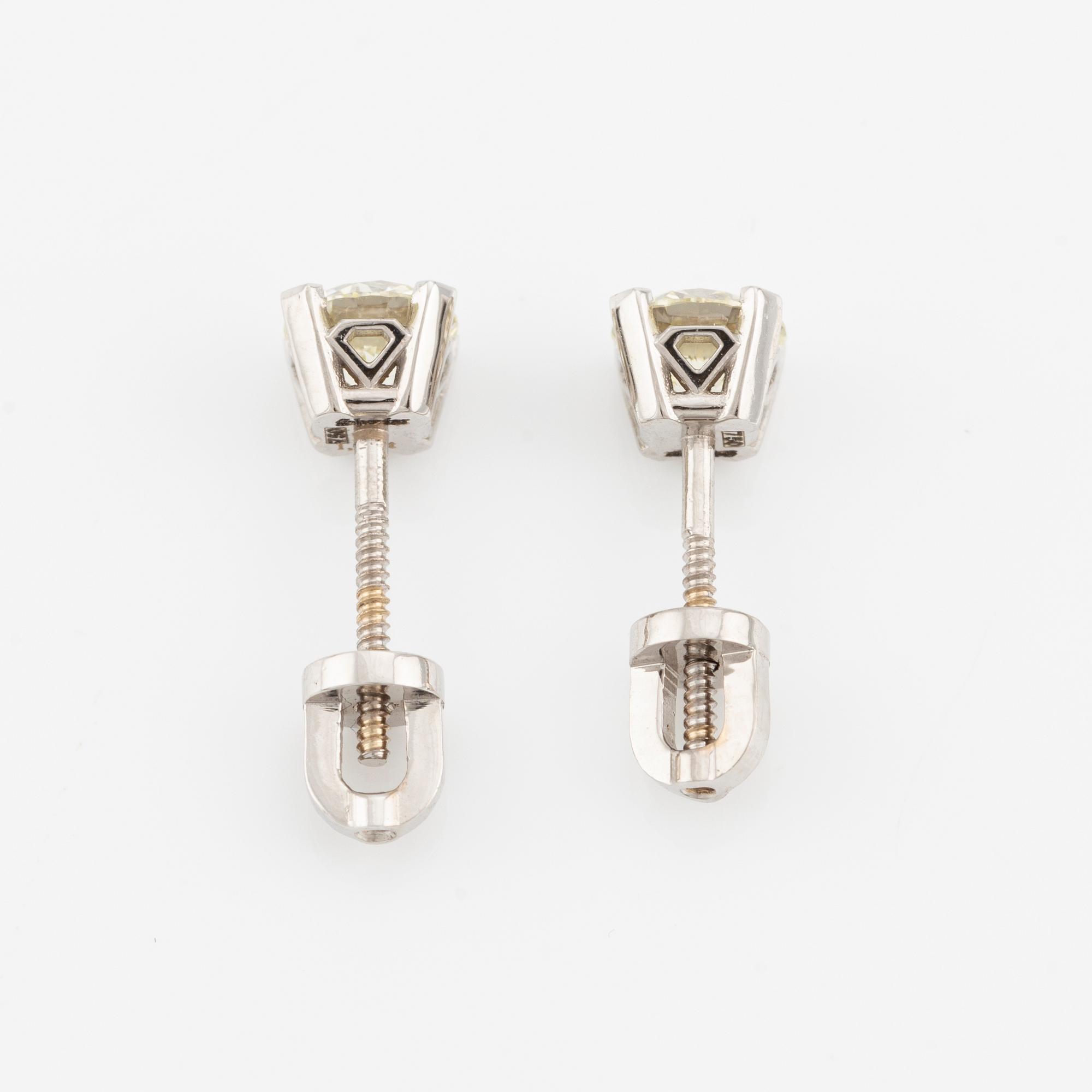 A pair of 18K gold earrings with round brilliant-cut diamonds.