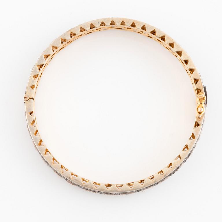 A faceted diamond bangle.