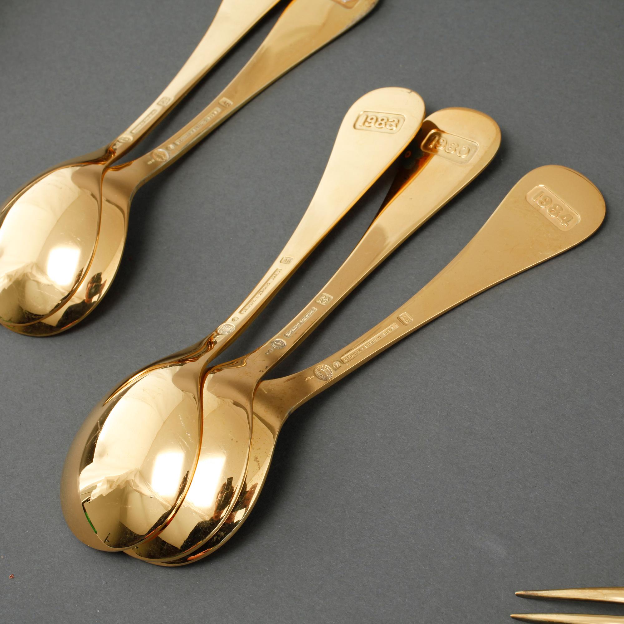 GEORG JENSEN, årsskedar, 19 st, förgyllt silver, samt årssked och gaffel, A. Michelsen, förgyllt silver, 1970-/80-tal.