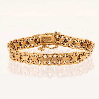 An 18K gold bracelet.