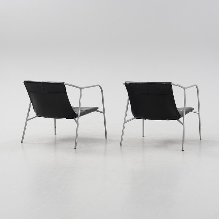 A pair of leather-upholstered easy chairs from Fasem, Italy.