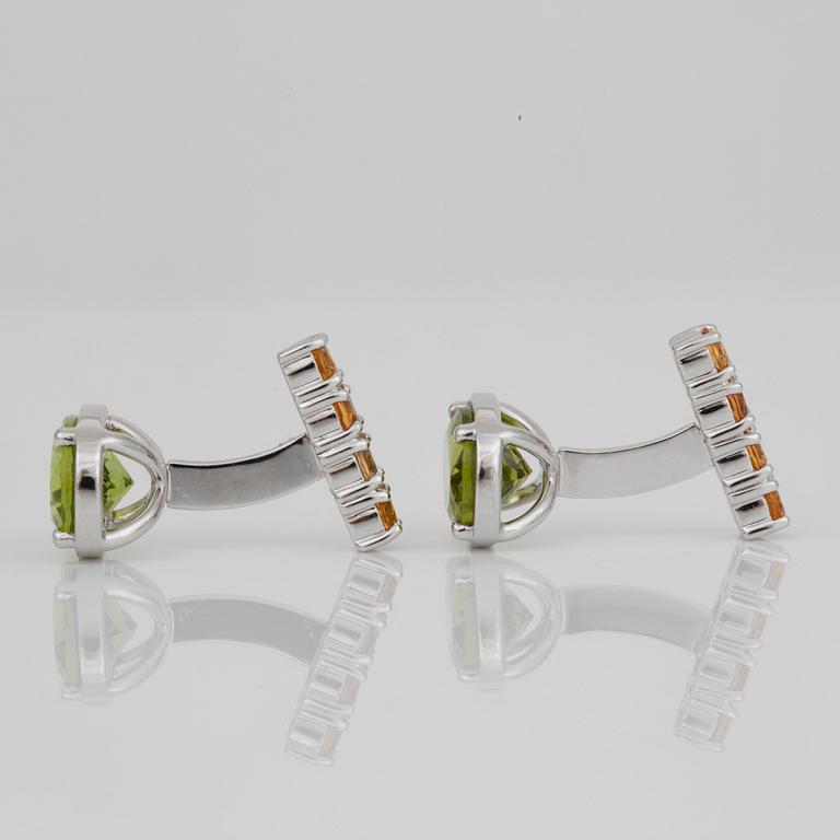 A pair of peridot and sapphire cufflinks. Peridots circa 6.10 cts and yellow sapphires circa 1.50 cts in total.