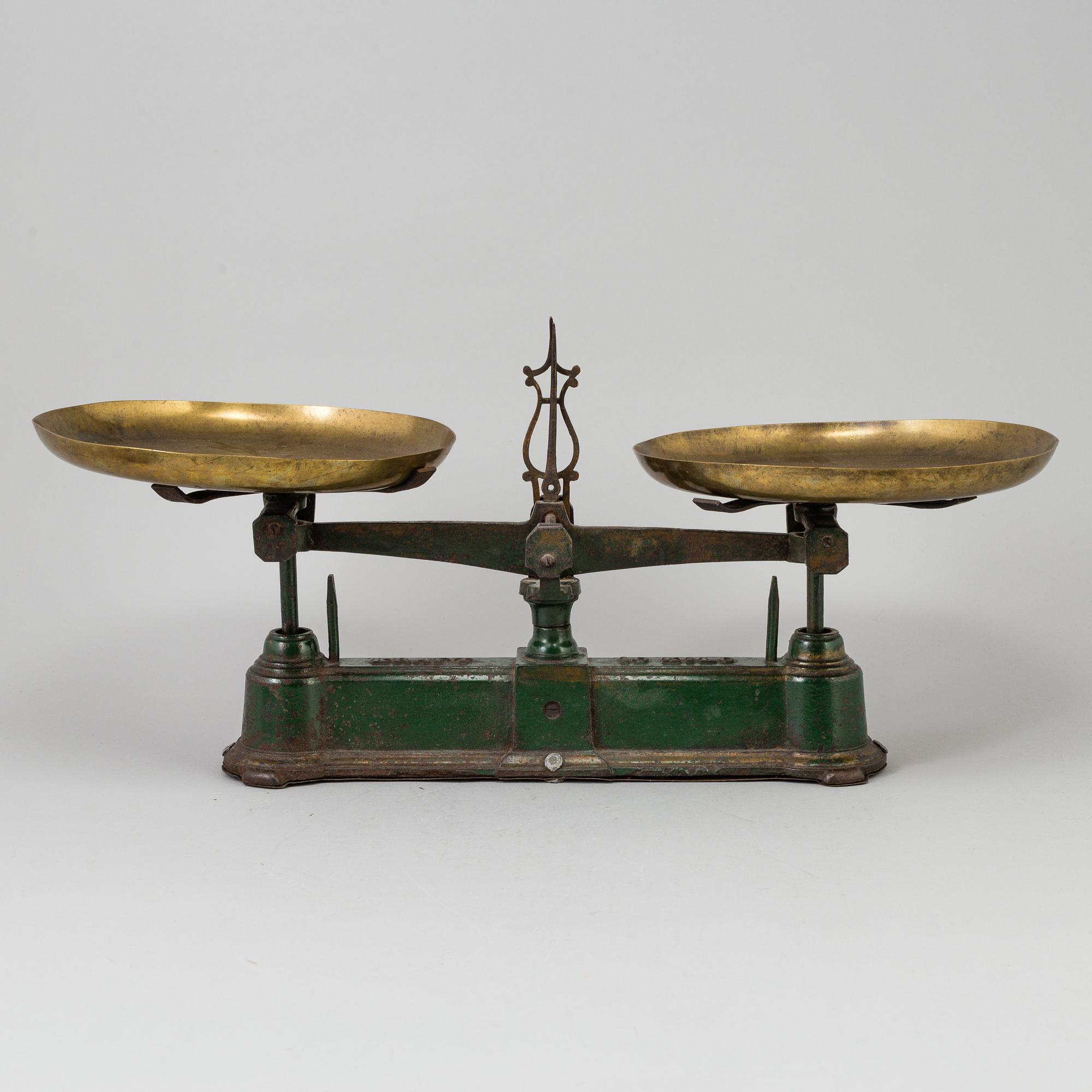 A 20th century cast iron balance with brass and iron weights, partly Skultuna, Sweden.