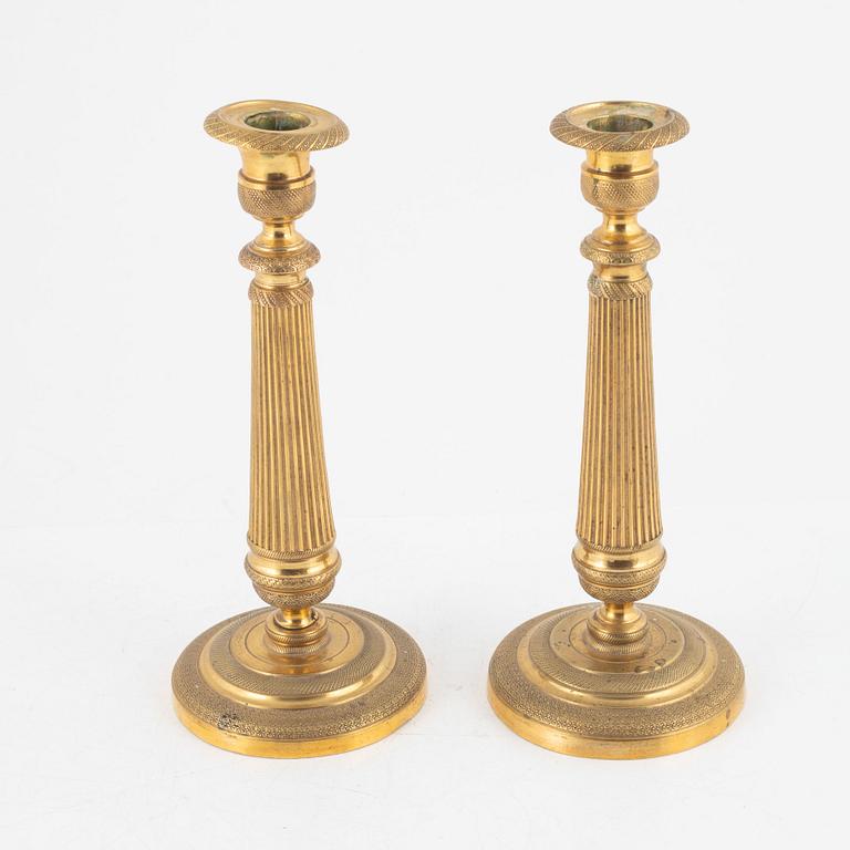 A pair of gilt brass Empire candlesticks, early 19th century.