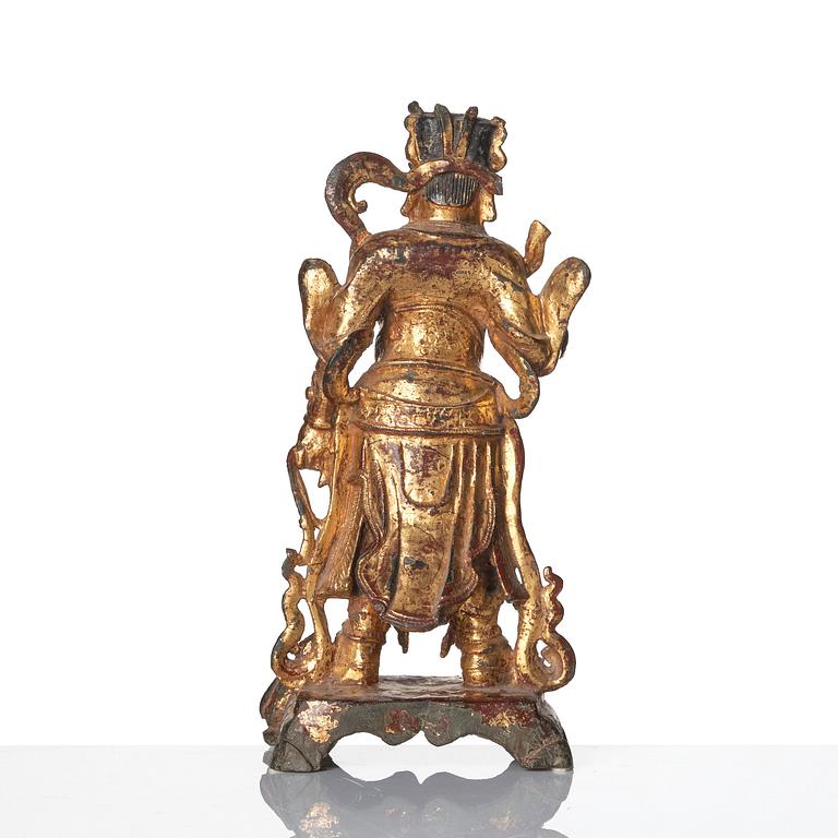 A parcel-gilt bronze figure of a guardian, Ming dynasty (1368-1644).