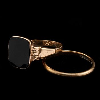 RINGAR, 2 st, 20k samt 18k guld med onyx, Skövde respektive Köping, 1900-talets mitt. Total vikt 8 g.