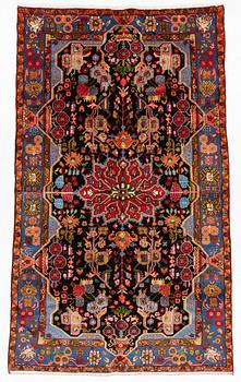 An oriental rug, ca 234 x 134-144 cm.