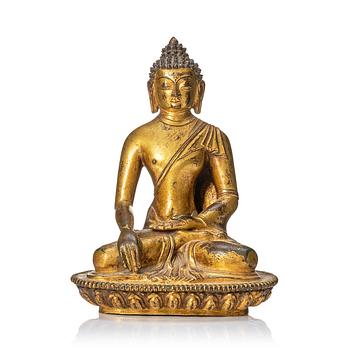 A gilt copper alloy figure of buddha, Nepal, 18th Century.