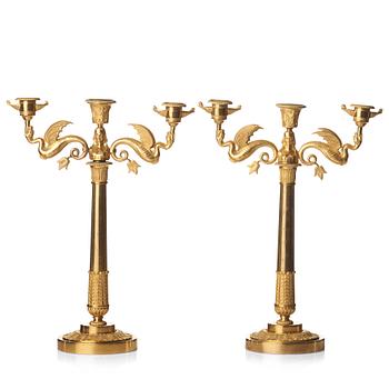 A pair of Empire early 19th century gilt bronze three-light candelabra.