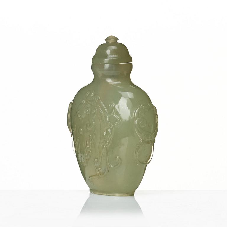 A Chinese carved nephrite snuff bottle with cover.