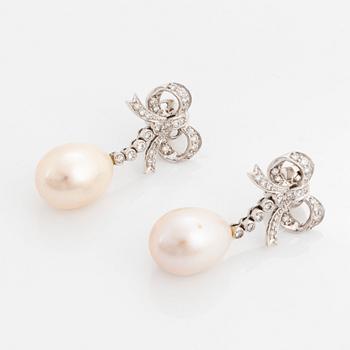 A pair of 18K gold and cultured pearl earrings set with round brilliant-cut diamonds.