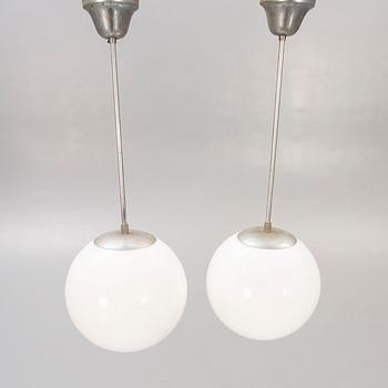 A pair of 1930s glass and chromed ceiling lights.