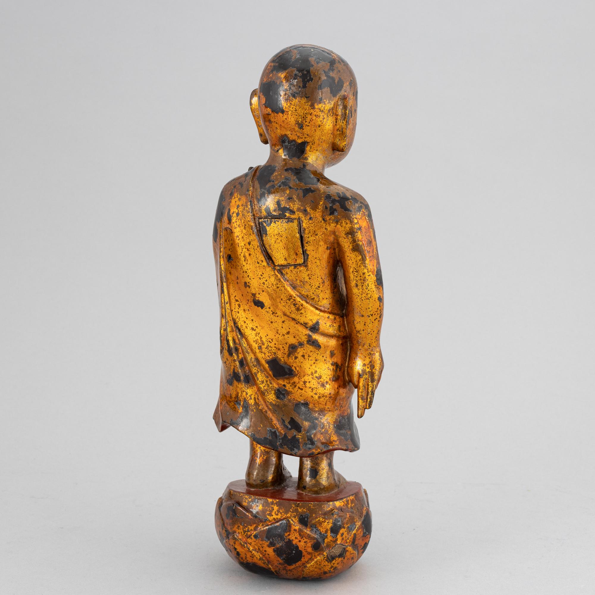 A Chinese wood gilt and lacquer sculpture of a boy, 20th Century.