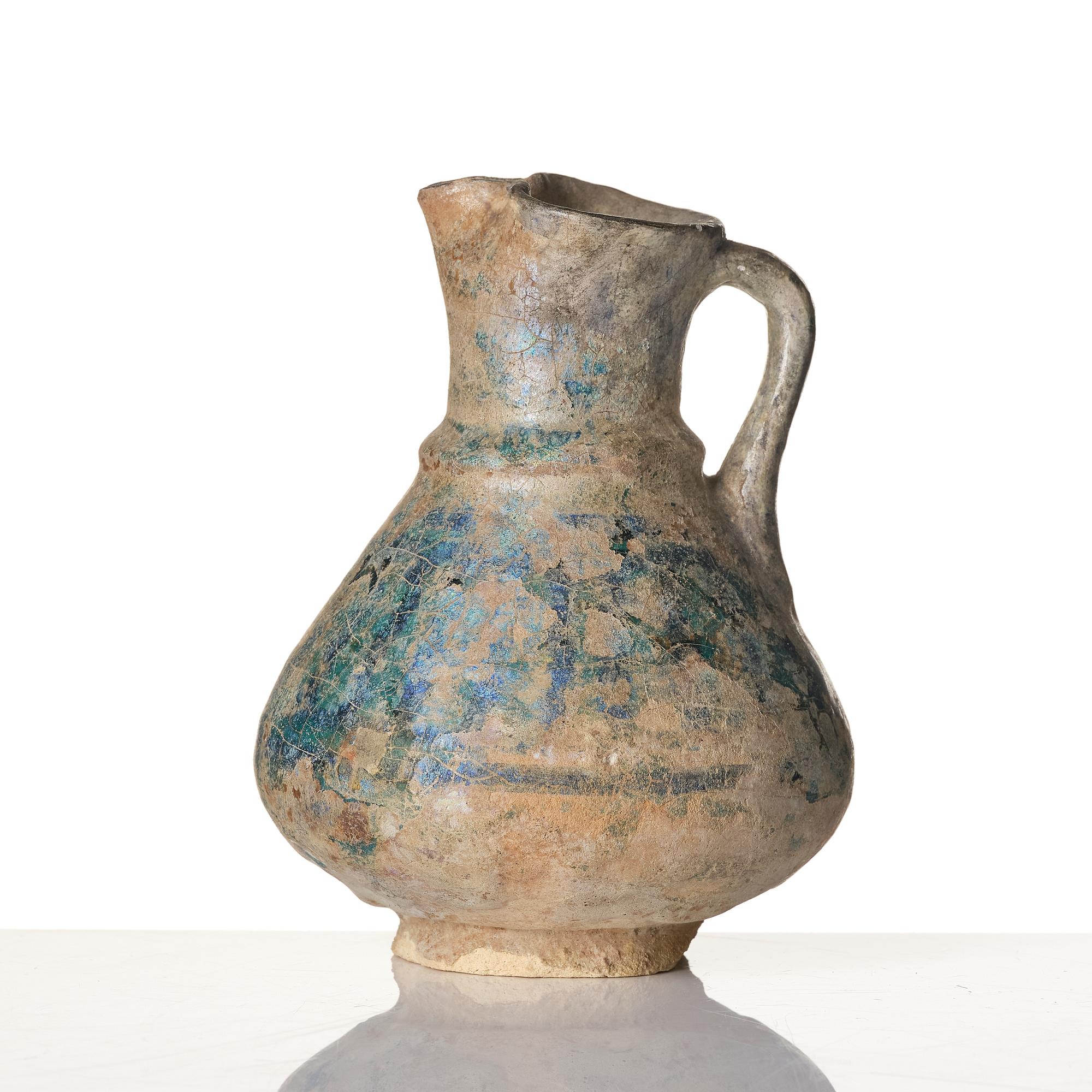 A turquoise-glazed Keshan jug, Persian, 13th century.