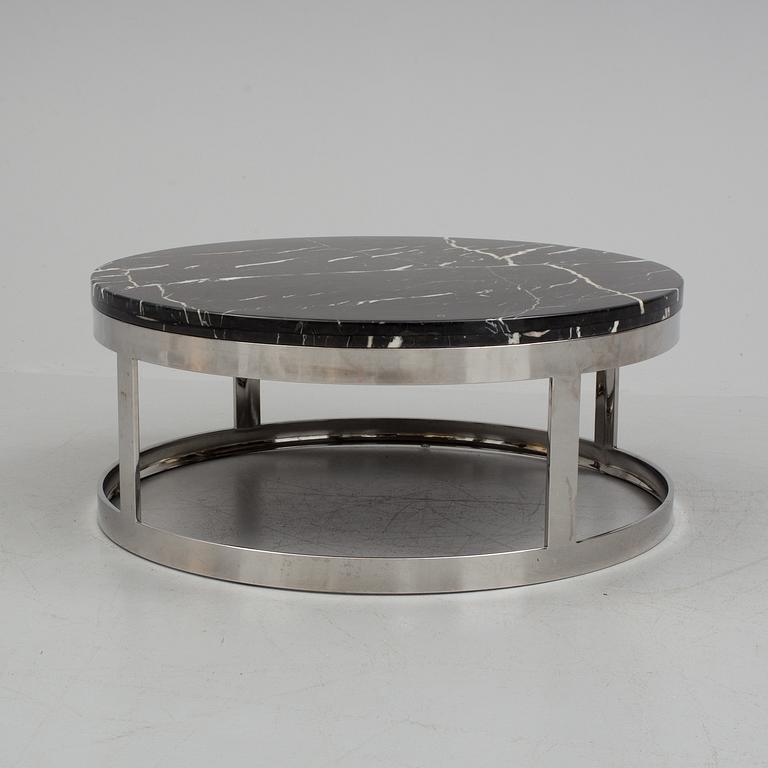 A 1970s stone and crome coffee table.