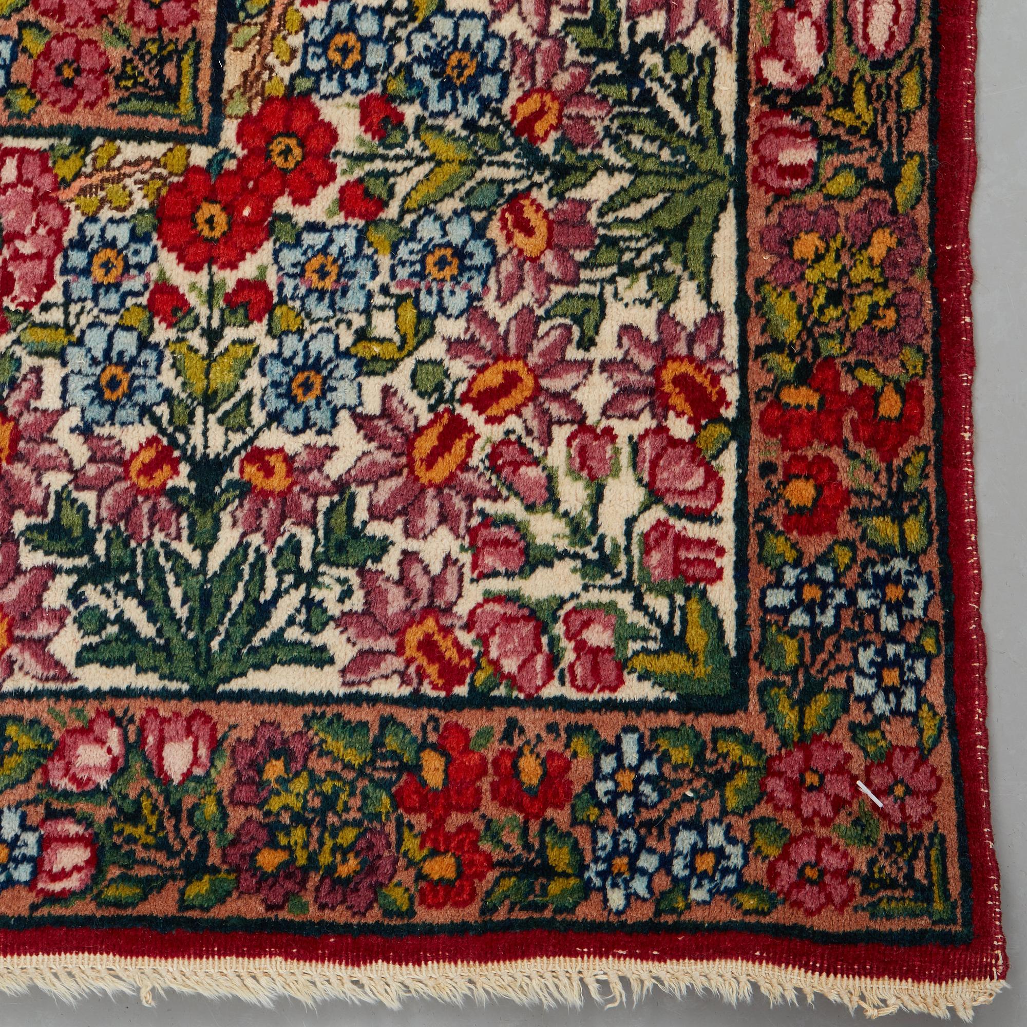 A RUG, a semi-antique Kerman "mille-fleur", ca 198,5 x 136,5 cm.