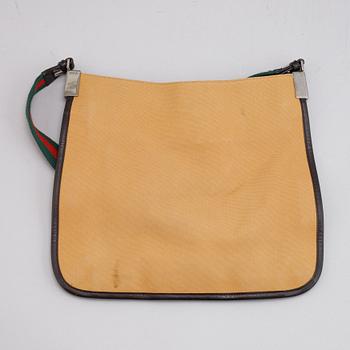 Gucci, a canvas handbag.