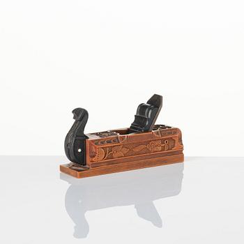 A Swedish carved ebony, boxwood and bone plane, dated 1748.