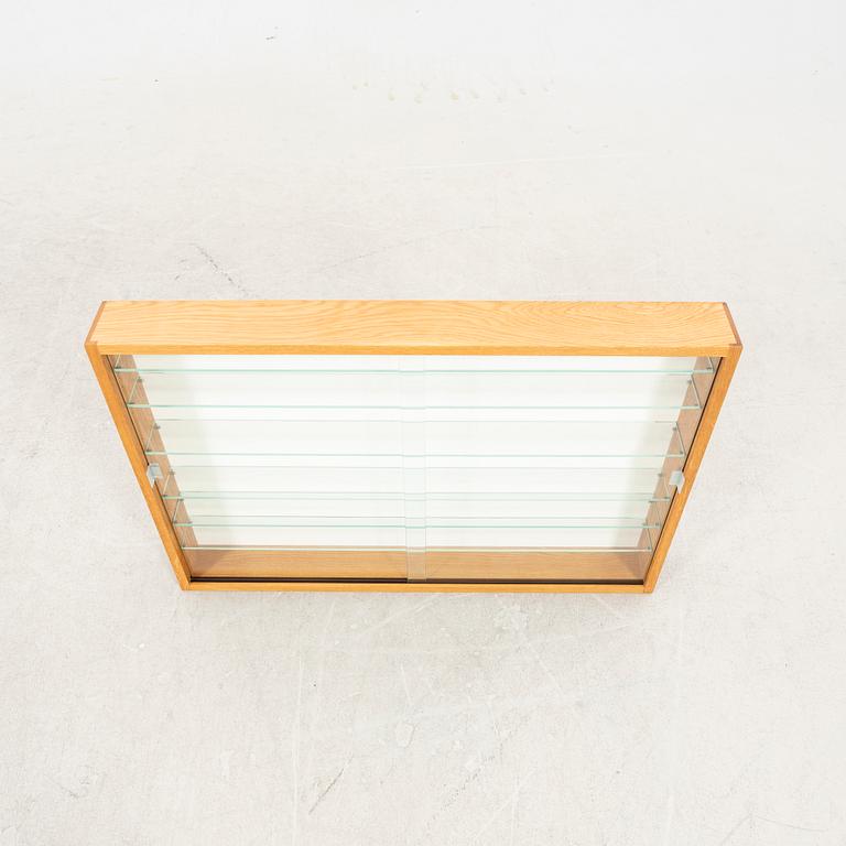 An oak display cabinet, later part of the 20th Century.