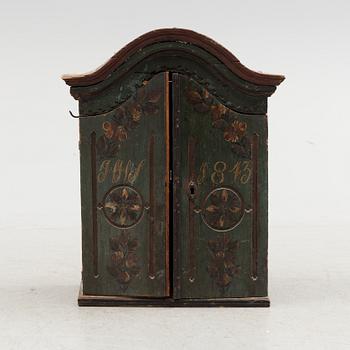 a wooden cabinet from 1843.