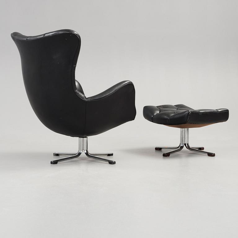 A Gustav Axel Berg 'Status' black leather easy chair with ottoman, Bröderna Andersson 1960's-70's.