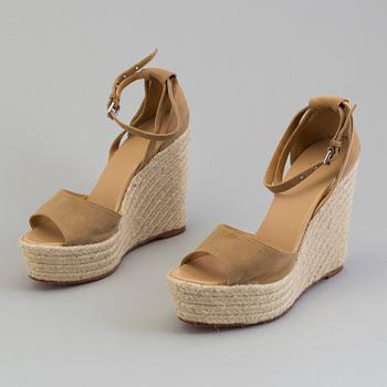 A beige suede platform sandals by Hermès.