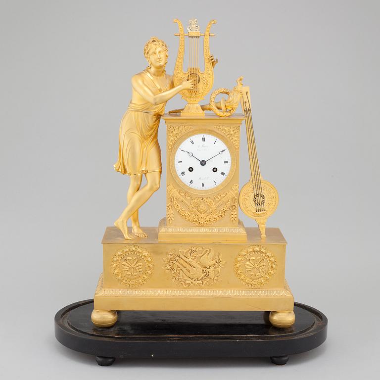 An Empire table clock, dial marked "L Ravrio Bronzier à Paris Mesnil H", fist half of the 20th century.