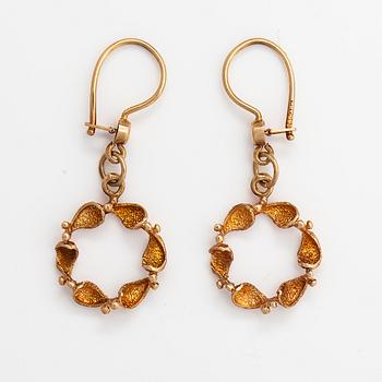 A pair of 14K gold earrings.