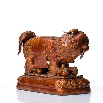 A cold gilt and lacquered copper alloy sculpture of a buddhist lion, Tibeto-Chinese/Mongolian, 18th Century.