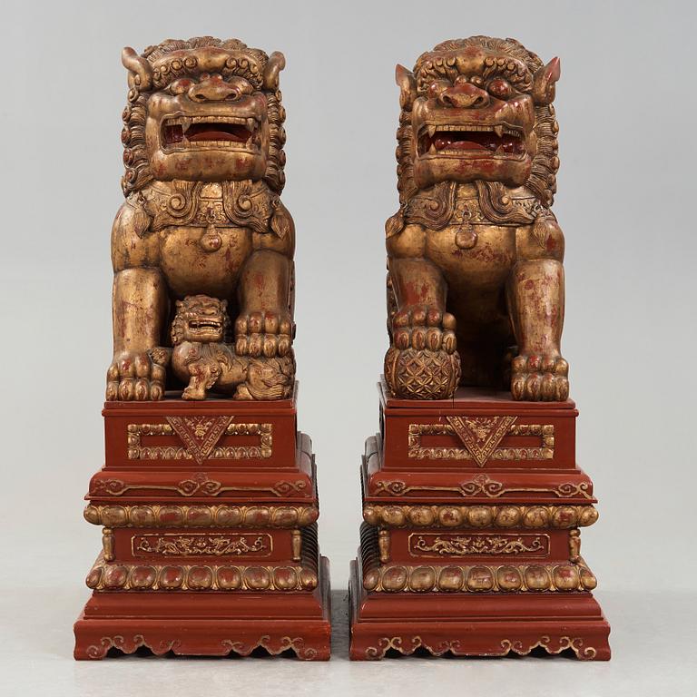 A pair of Chinese massive lacquered Buddhist lions, first half of the 20th Century.