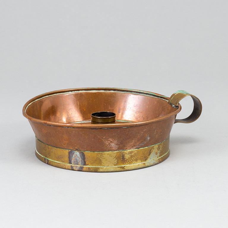 A 19th century copper and brass night light holder.