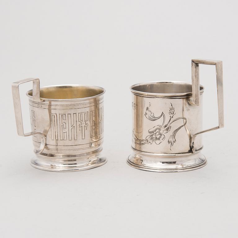 Two tea glass holders in silver, one with mark of Ivan Saltykov, Moscow 1889, the other one marked Moscow 1908-1917.