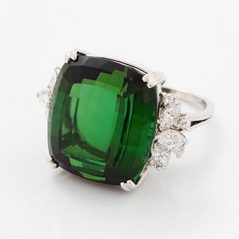 An 18K white gold ring set with a green tourmaline and round- and marquise brilliant-cut diamonds.