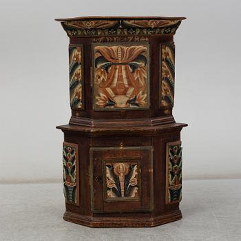 A Swedish corner cabinet dated 1784.