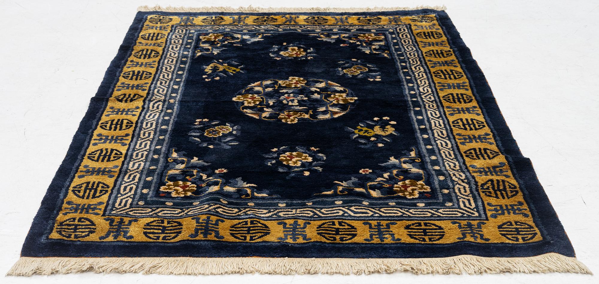 A semi-antique silk Chinaese 'Antique finish' rug, c. 175 x 122 cm.