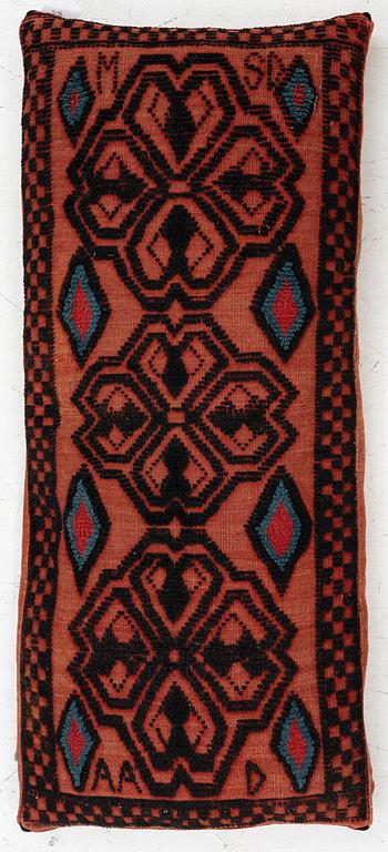 A carriage cushion, knotted pile in relief, ca 106 x 47, southwest of Scania, Sweden, circa 1800.