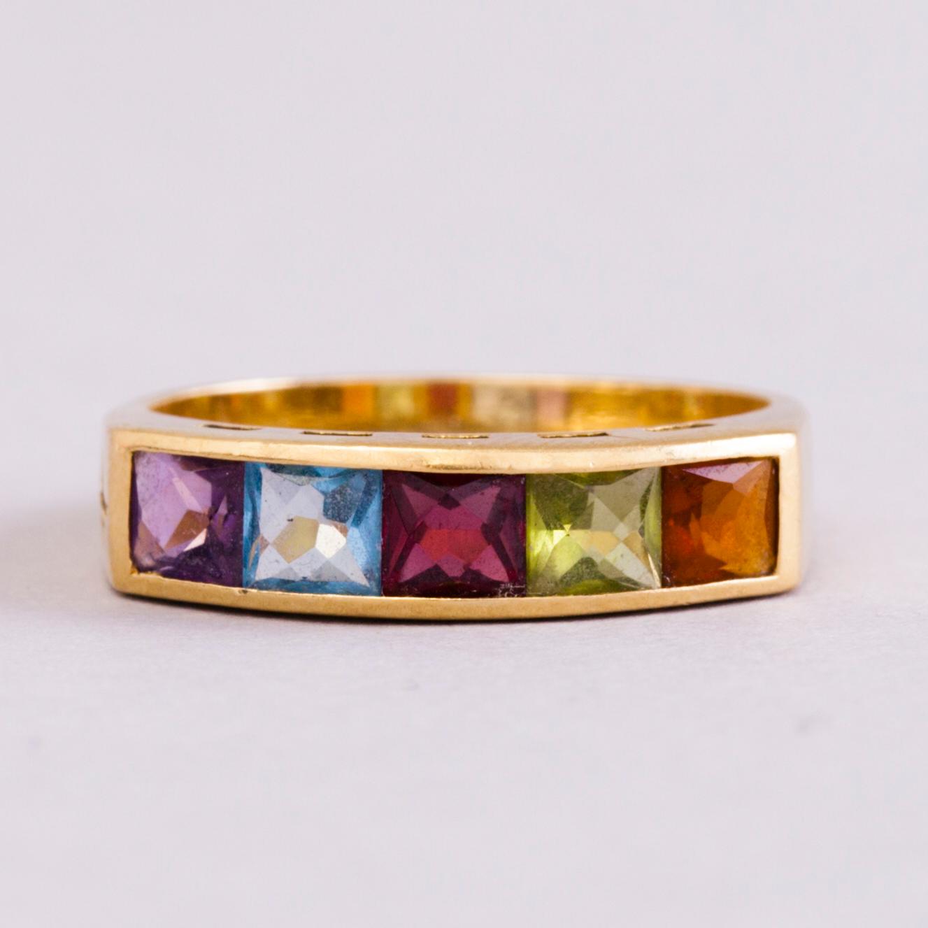 A 18K gold ring with 5 different stones: citrine, amethyst, topaz, garnet, peridot and a small diamond. Probably H.Stern.