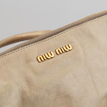 Miu Miu, a leather handbag.