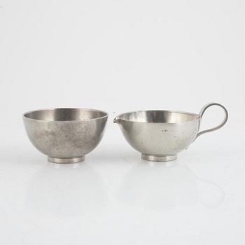 A pewter sugar bowl, cream jug, bowl and dish by Svenskt Tenn 1930s-1950s.