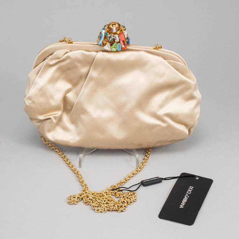 DOLCE & GABBANA, a satin clutch.
