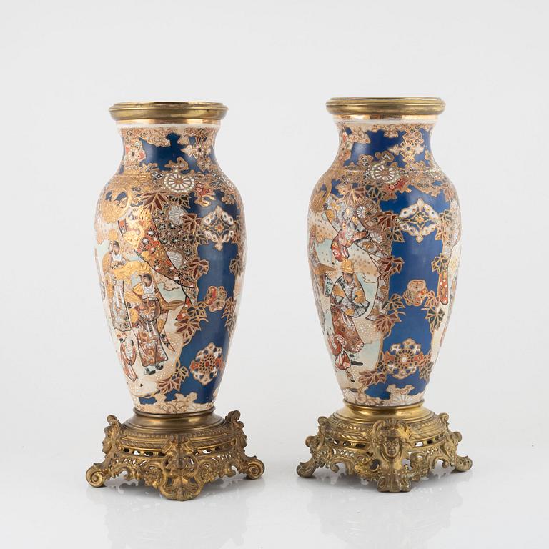 A pair of gilt-brass and satsuma ware seven-light candelabra, the porcelain Meiji period (1868-1912).