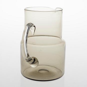 SAARA HOPEA, A glass pitcher and six glasses in rattan basket, for Nuutajärvi. Designed year 1952.