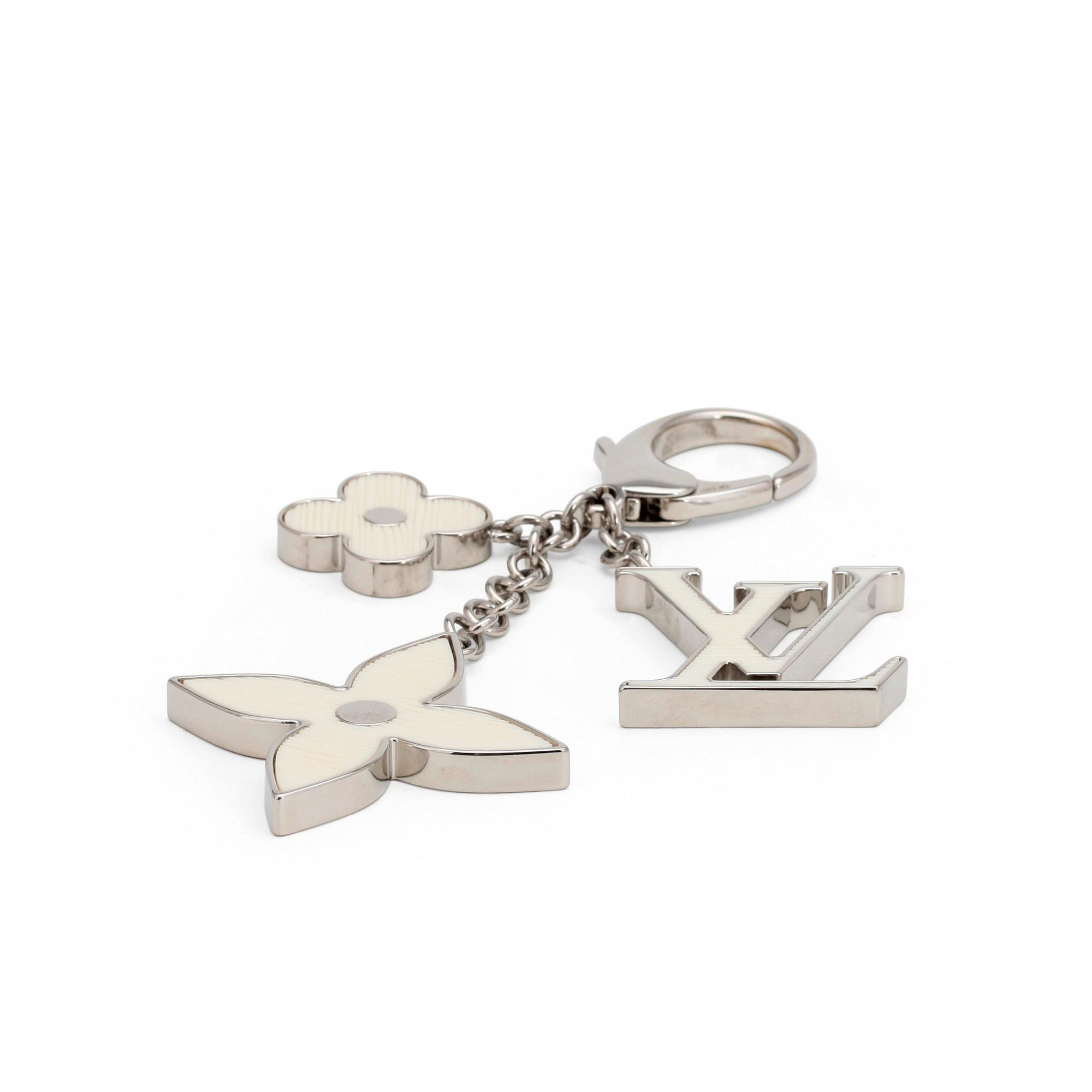 LOUIS VUITTON, a palladium finished brass and white bag charm, "Fleur d'epi".