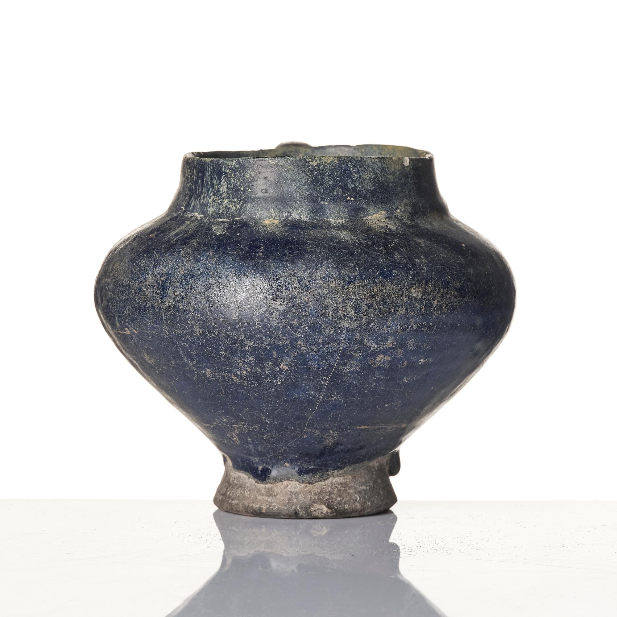 A blue-glazed Nishapur pottery Jug, Persia, 13th century.
