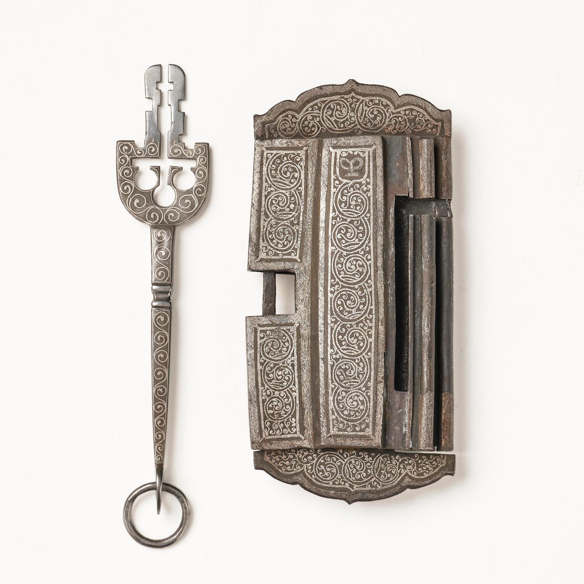 A Shokpa-shaped lock, inlaid with silver threads, Tibet, 19th century. 'Ashtamangala'.