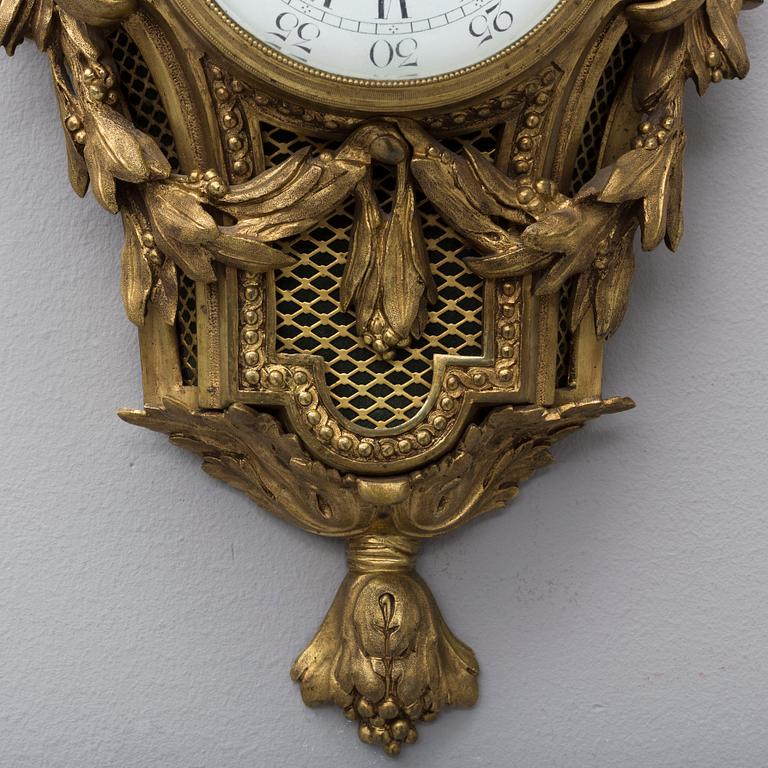 A brass wall clock marked A.W. Bruuns eftr, Lund from around year 1900.
