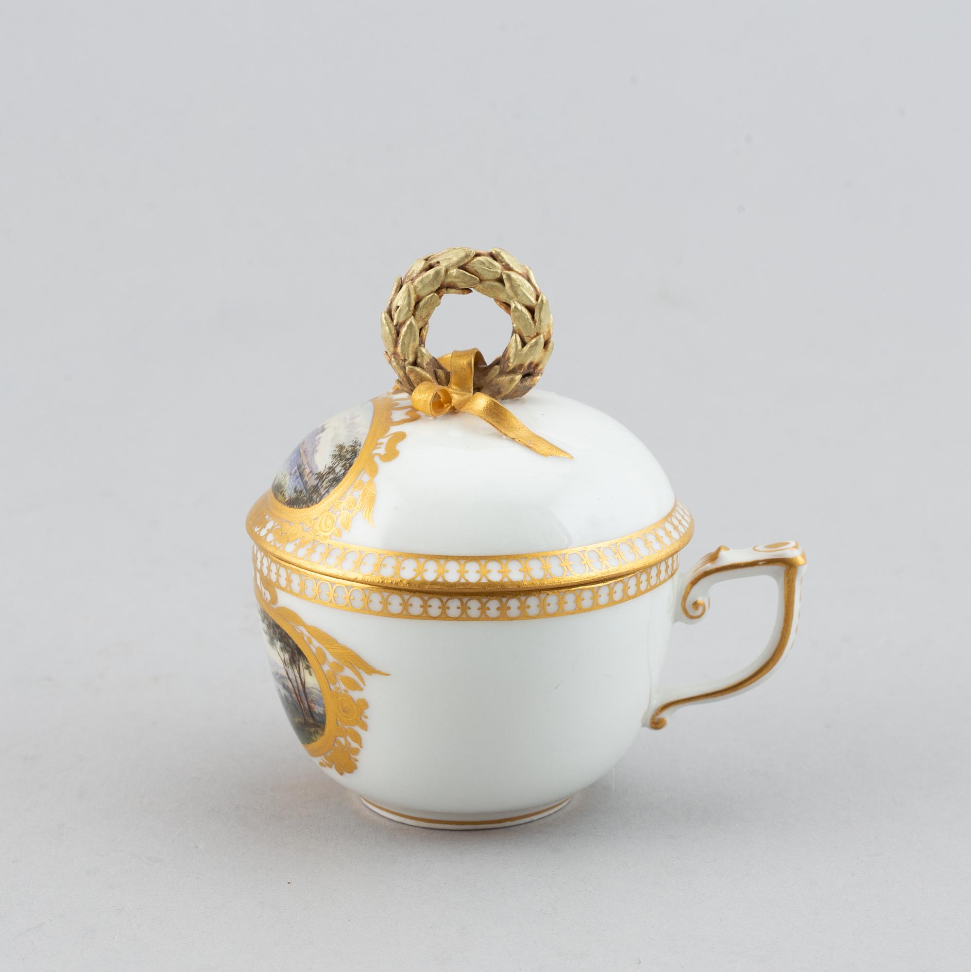 A 19th century Meissen miniature lidded porcelain cup decorated with views of Mainau.