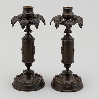A pair of mid 19th century late Empire candlesticks.